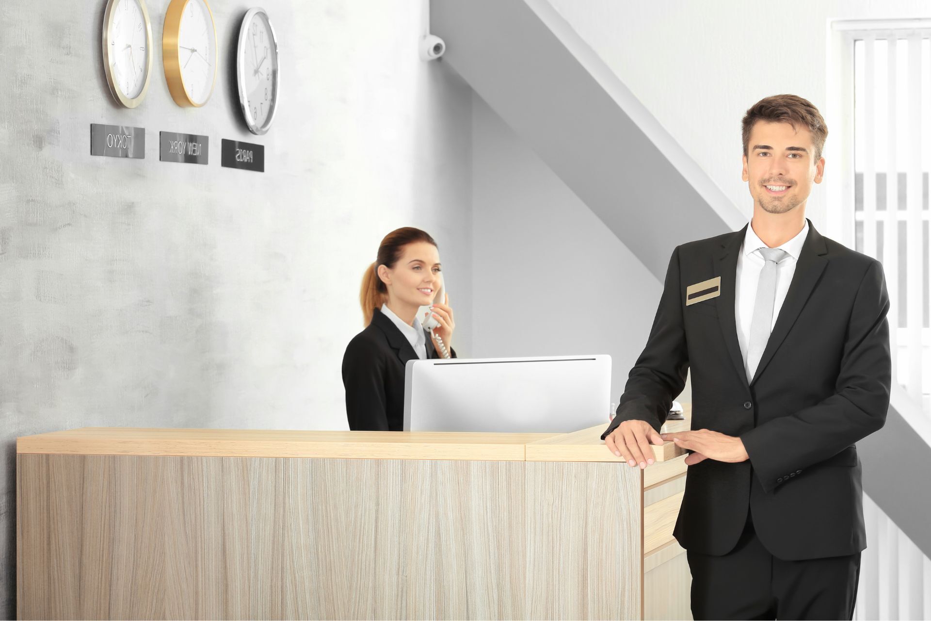 Hospitality professionals at a hotel reception desk